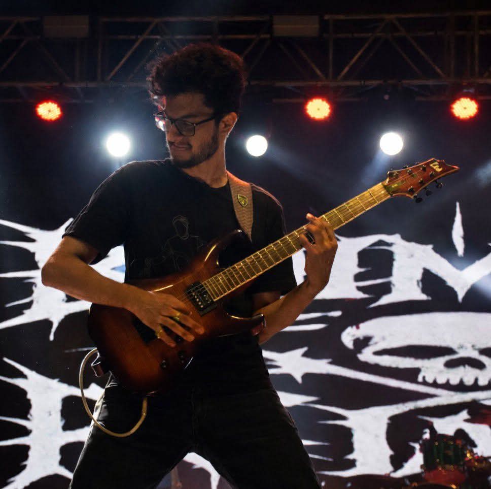 Sayontan Dey performing on electric guitar on stage